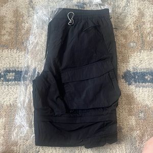 Men’s Kith Wrinkle Nylon Convertible Pant II. Color black. Size large.